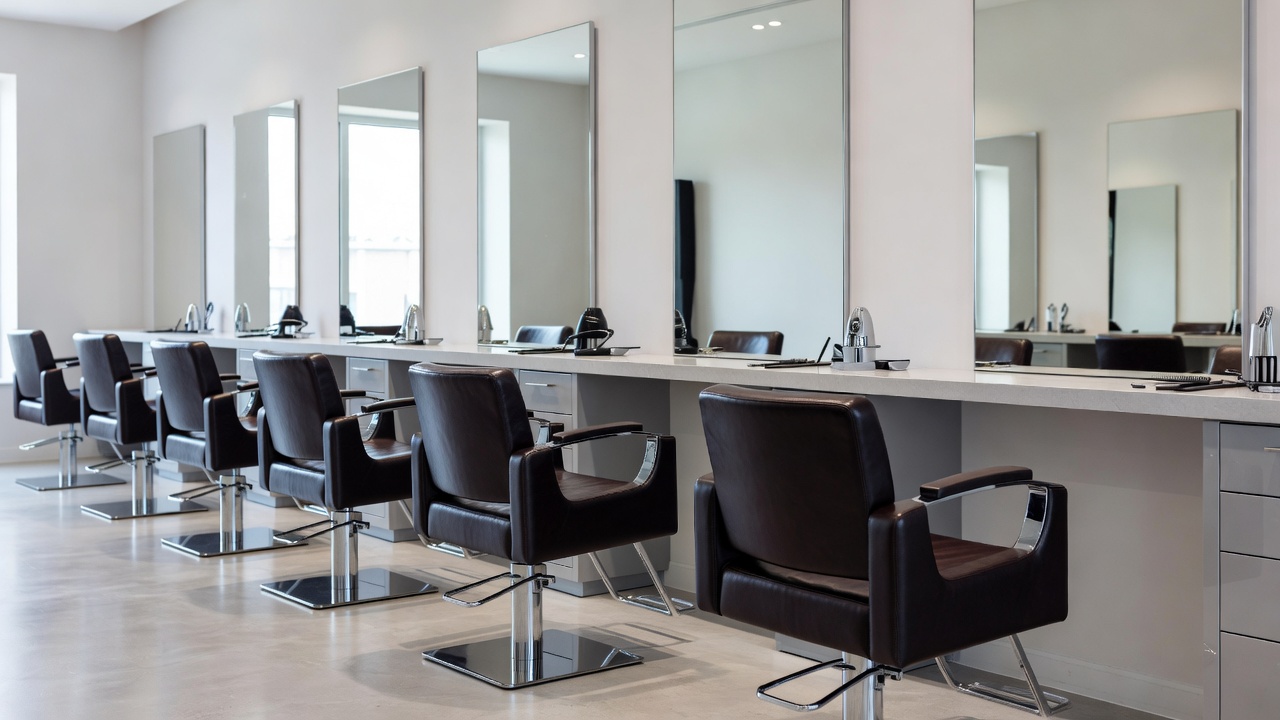 Salon interior with a row of genuine styling chairs, stations and wall mirrors